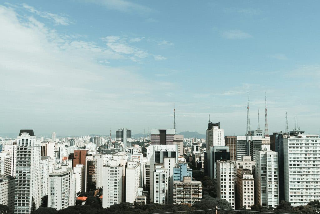 Large white buildings in Sao Paulo, Brazil, under a clear blue sky.