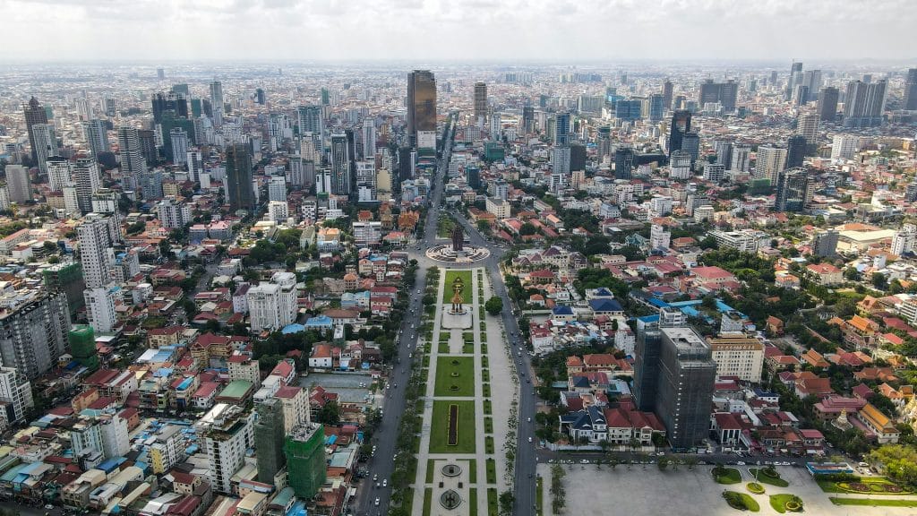 Aerial view of the city of Phnom Penh in Cambodia, by day. The photo is quite grey and sombre.